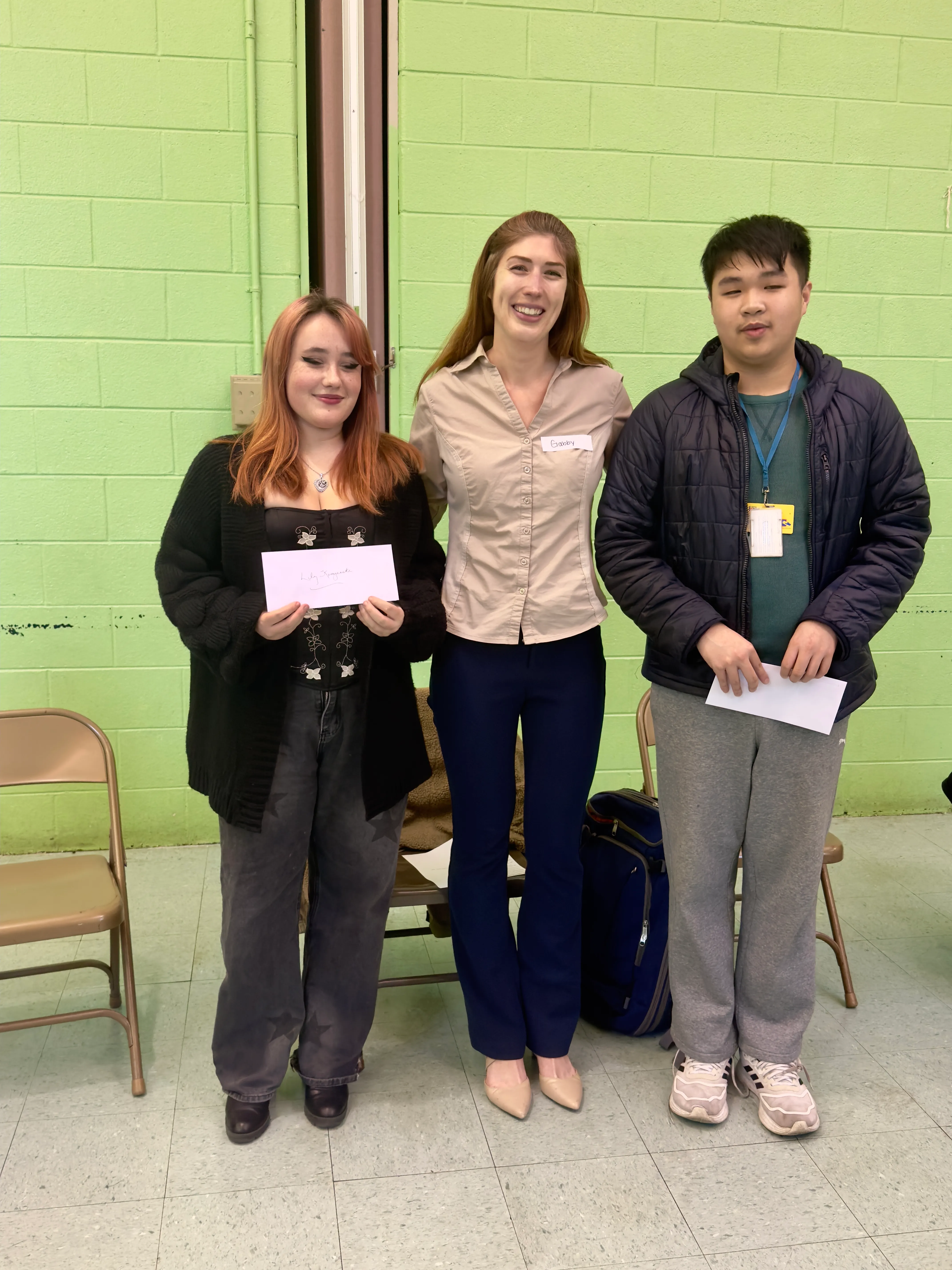 Scholarship winners Lily Kempinski (left) and Eric Zhang (right) with HEC education committee chair Gabrielle Thomas (center).